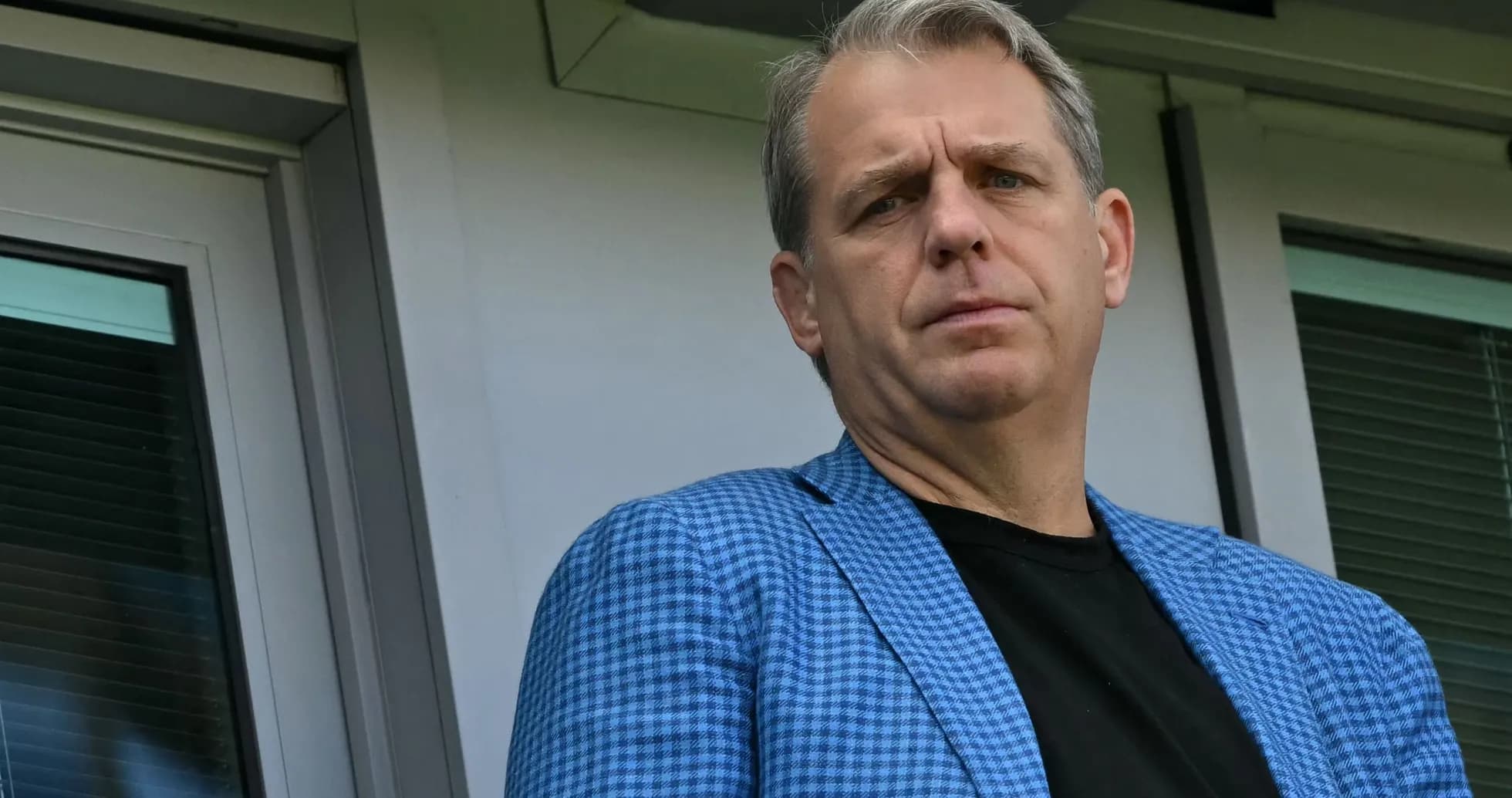 Person in a blue blazer looking towards the camera