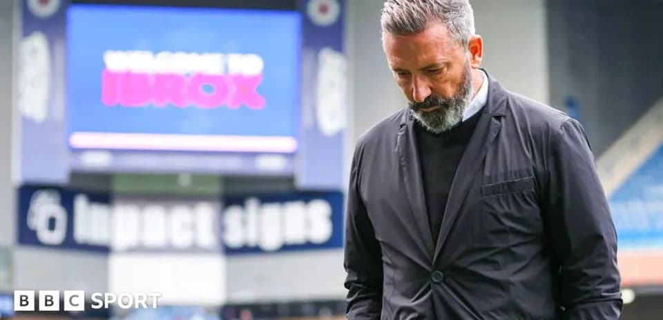 Men's football coach at Ibrox Stadium looking down
