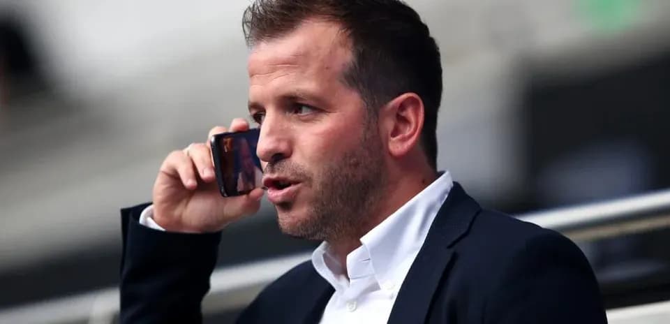 Person on phone in a stadium setting