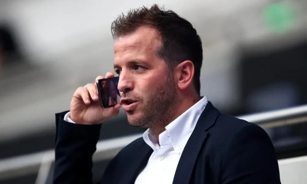 Person on phone in a stadium setting