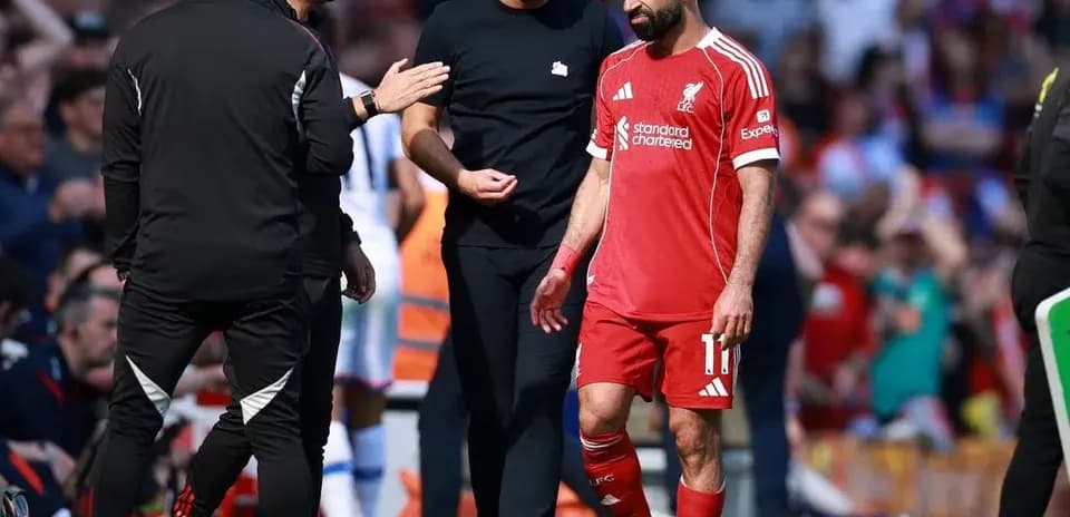 Mohamed Salah leaving the pitch with coaches