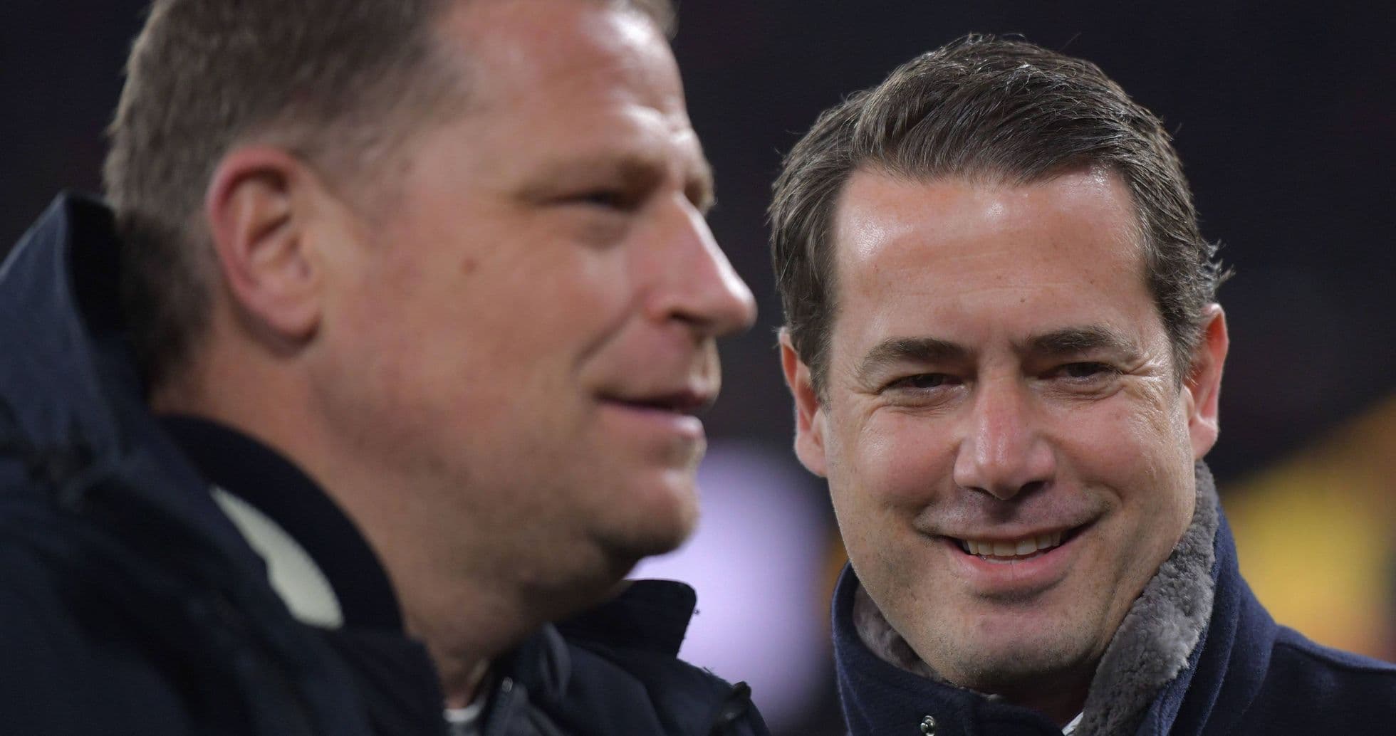 Two men talking on the sidelines of a match