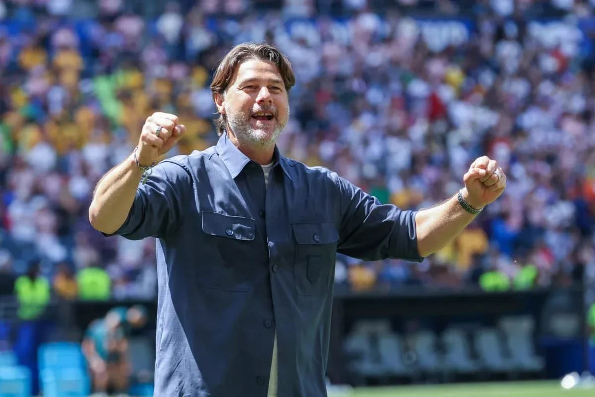 Coach celebrating with raised fists at stadium