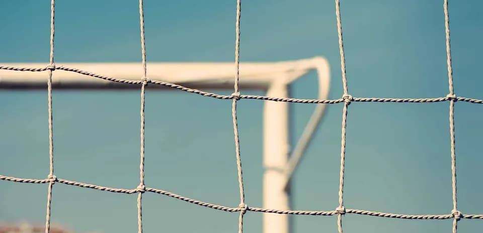 Football goal net with clear blue sky background