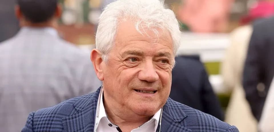 Man in a checked blazer at an event