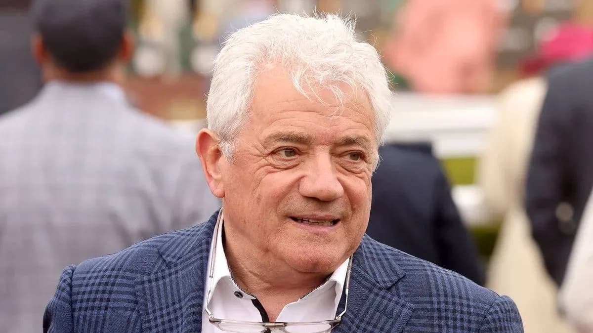 Man in a checked blazer at an event