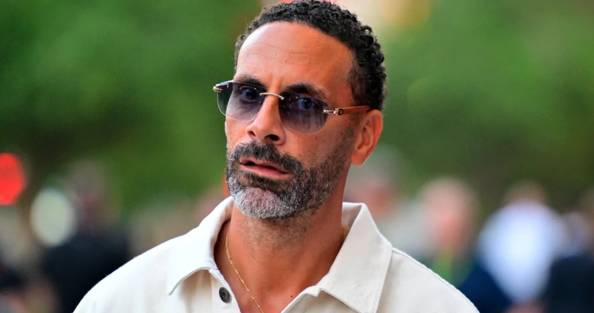 Man with sunglasses walking in urban setting