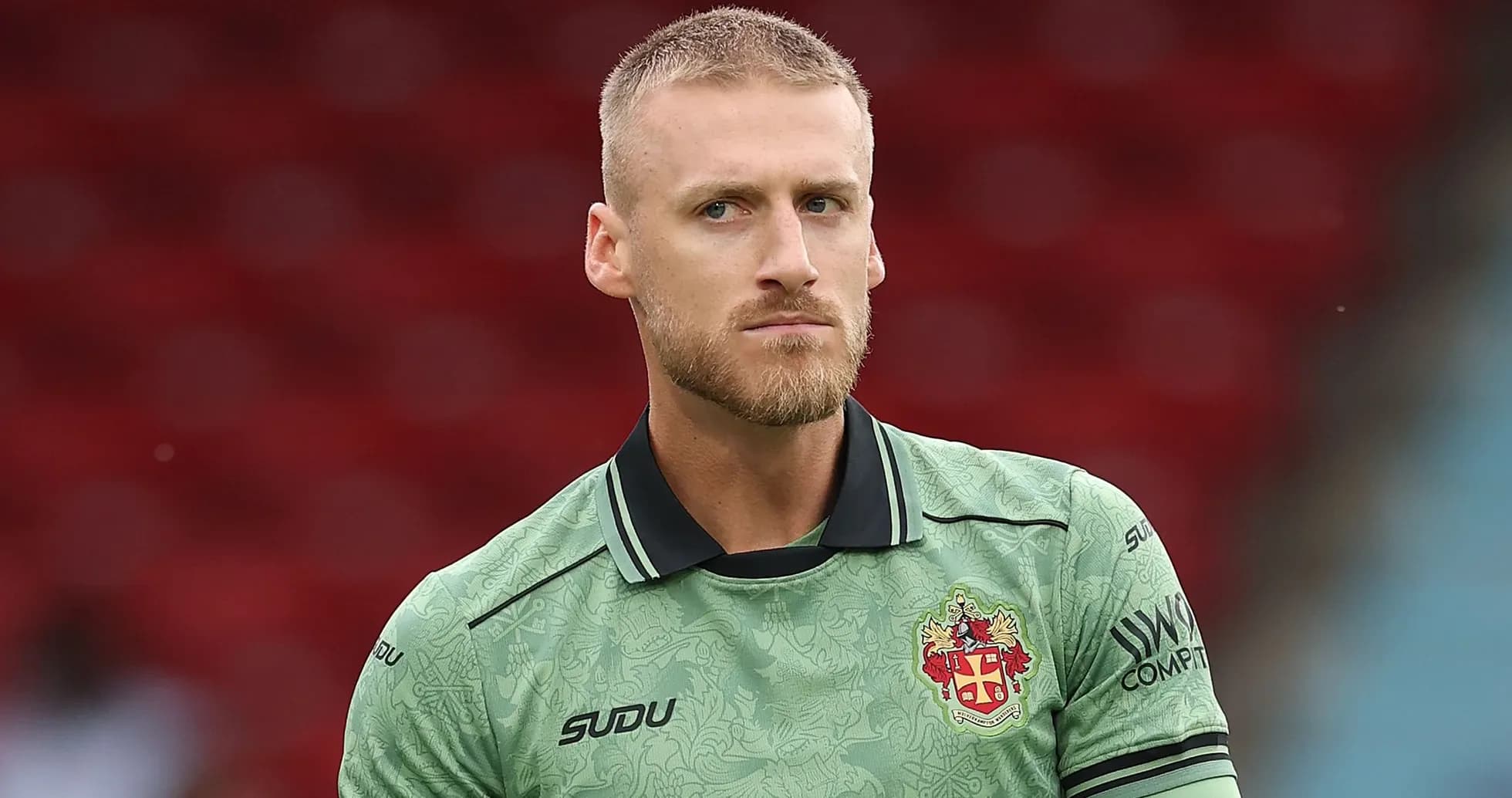 Goalkeeper in green kit before a match