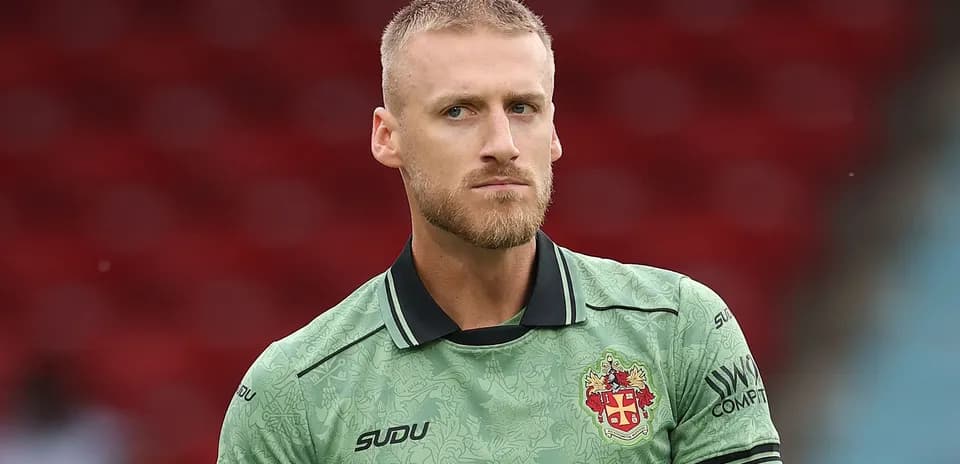 Goalkeeper in green kit before a match