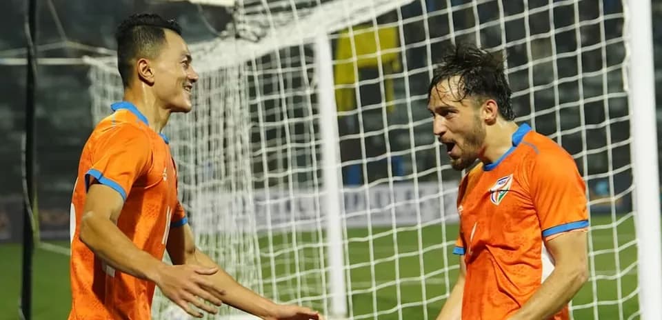 Players celebrating a goal on the field