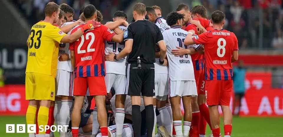 Players from both teams gathered around a fallen player