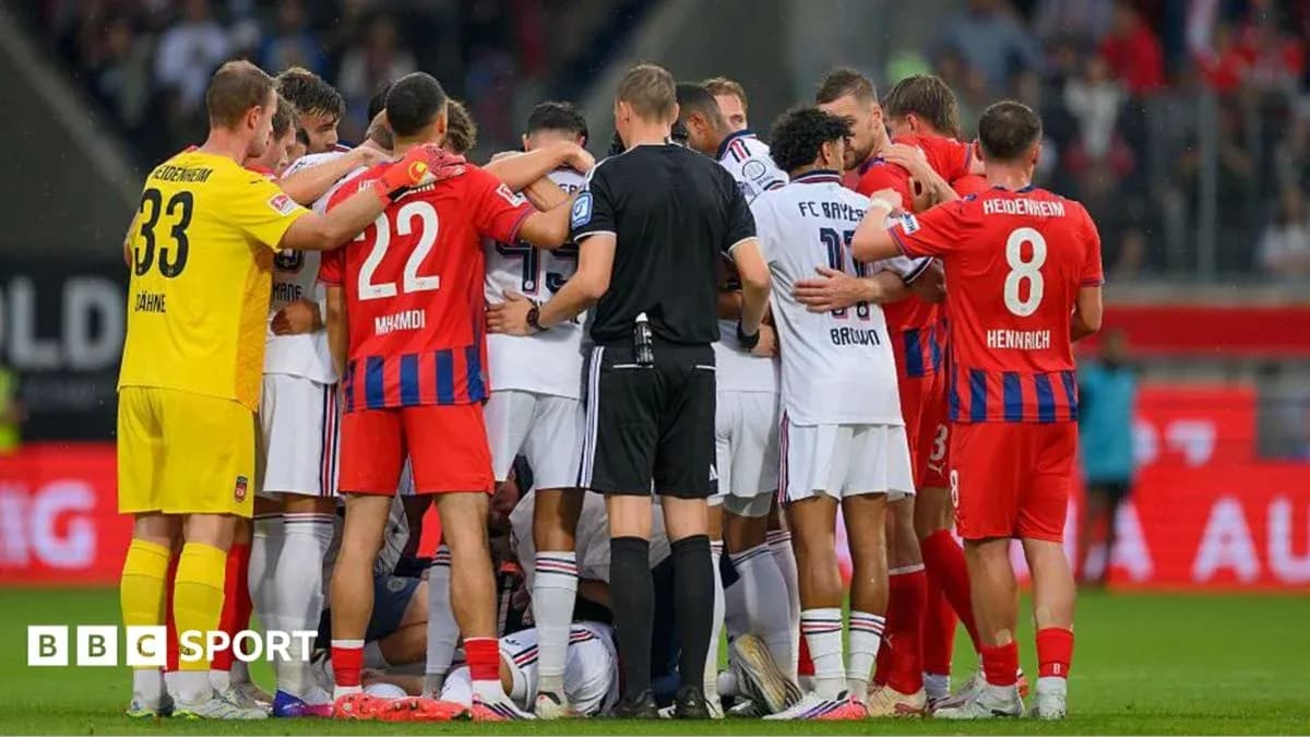 Players from both teams gathered around a fallen player