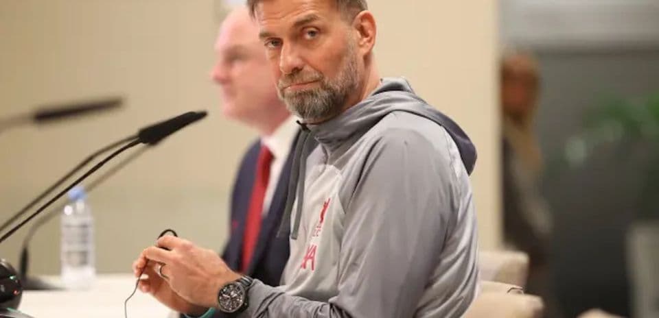 Manager speaking at press conference with microphone