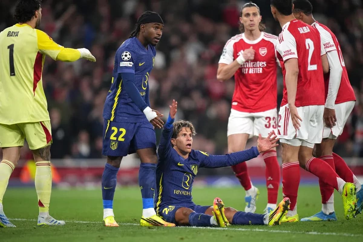 Atletico player on ground, teammates and opponents nearby