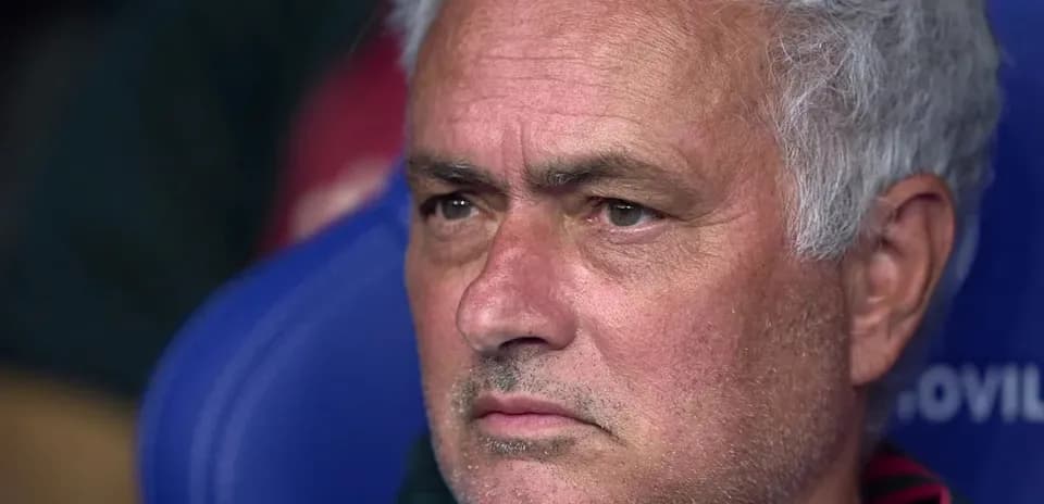 Coach observing match from the bench