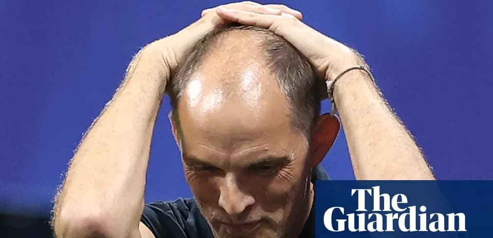 Coach holding head in apparent frustration during match