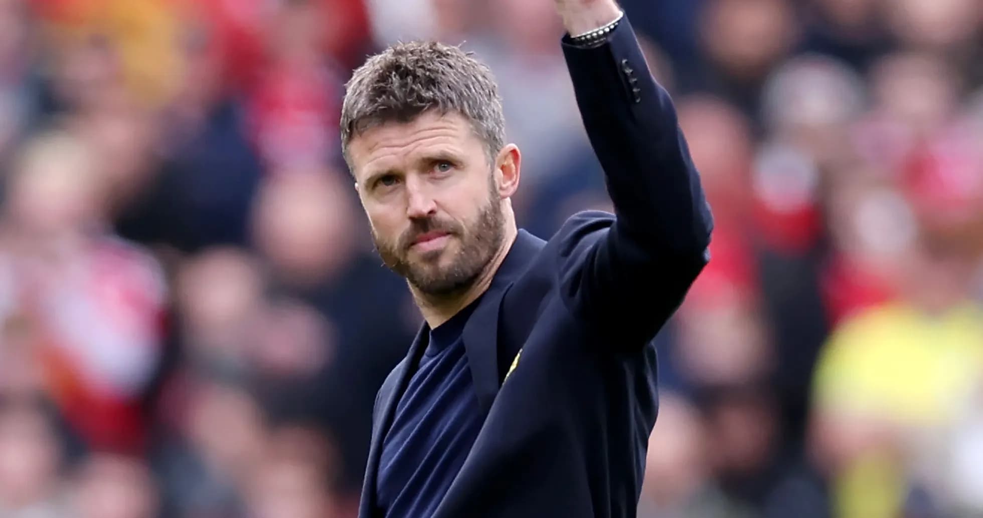 Coach waving to fans during match