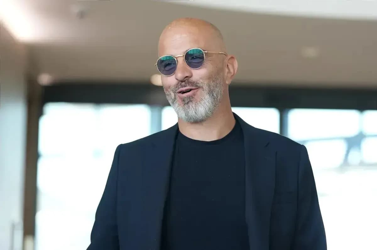 Man wearing sunglasses and a black suit