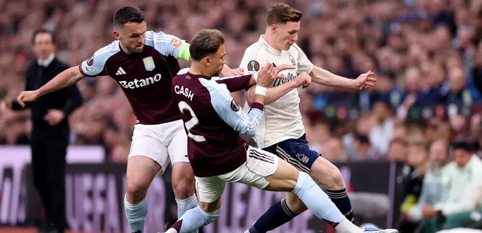 Aston Villa players challenging opponent for the ball