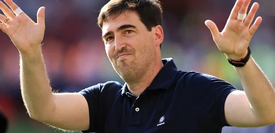 Person waving hands in sports venue