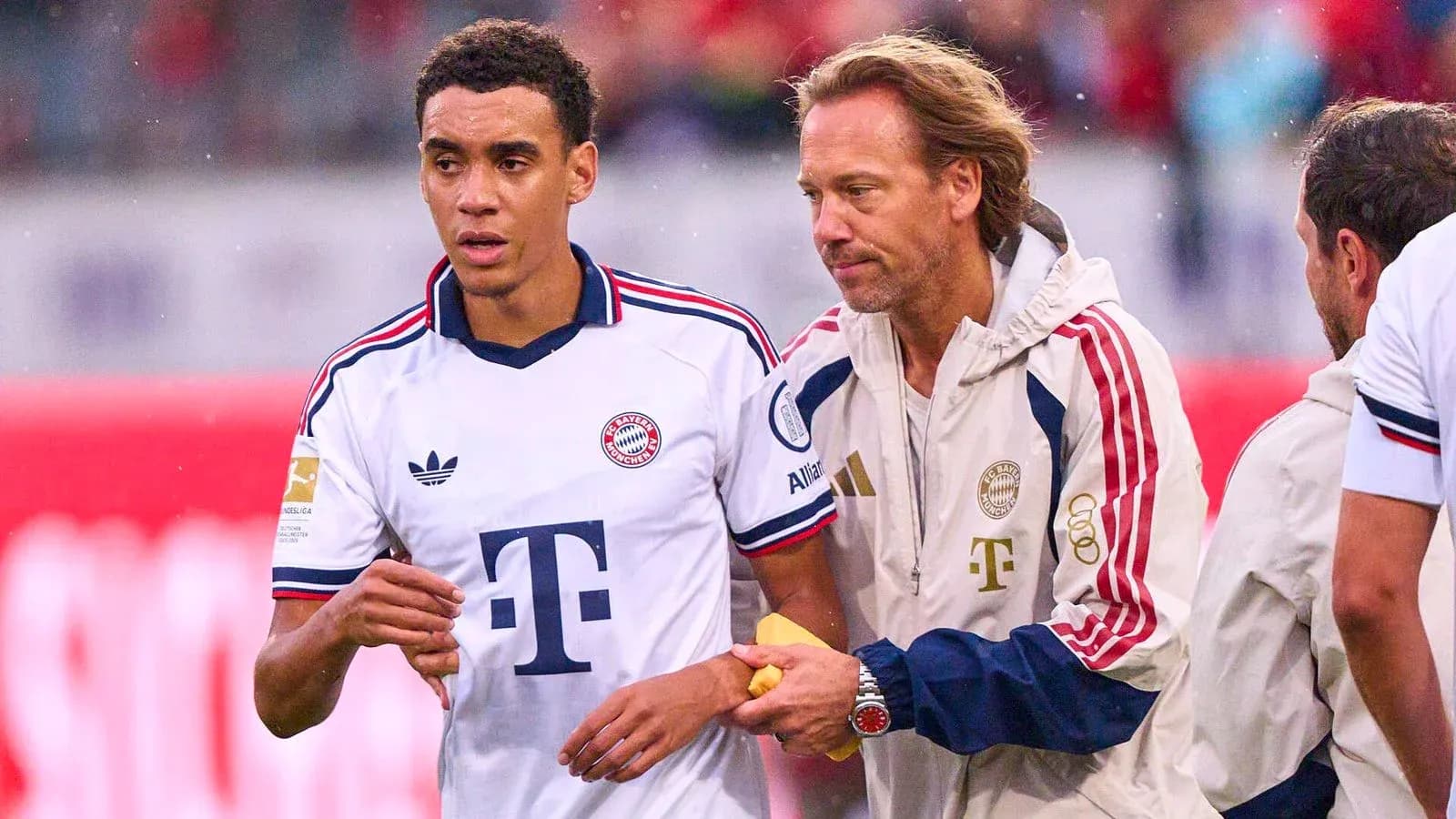Bayern Munich player receiving guidance from staff