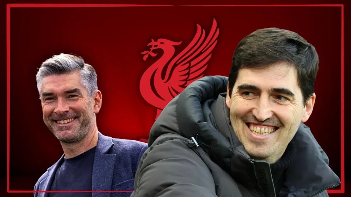 Two coaches smiling with Liverpool logo background