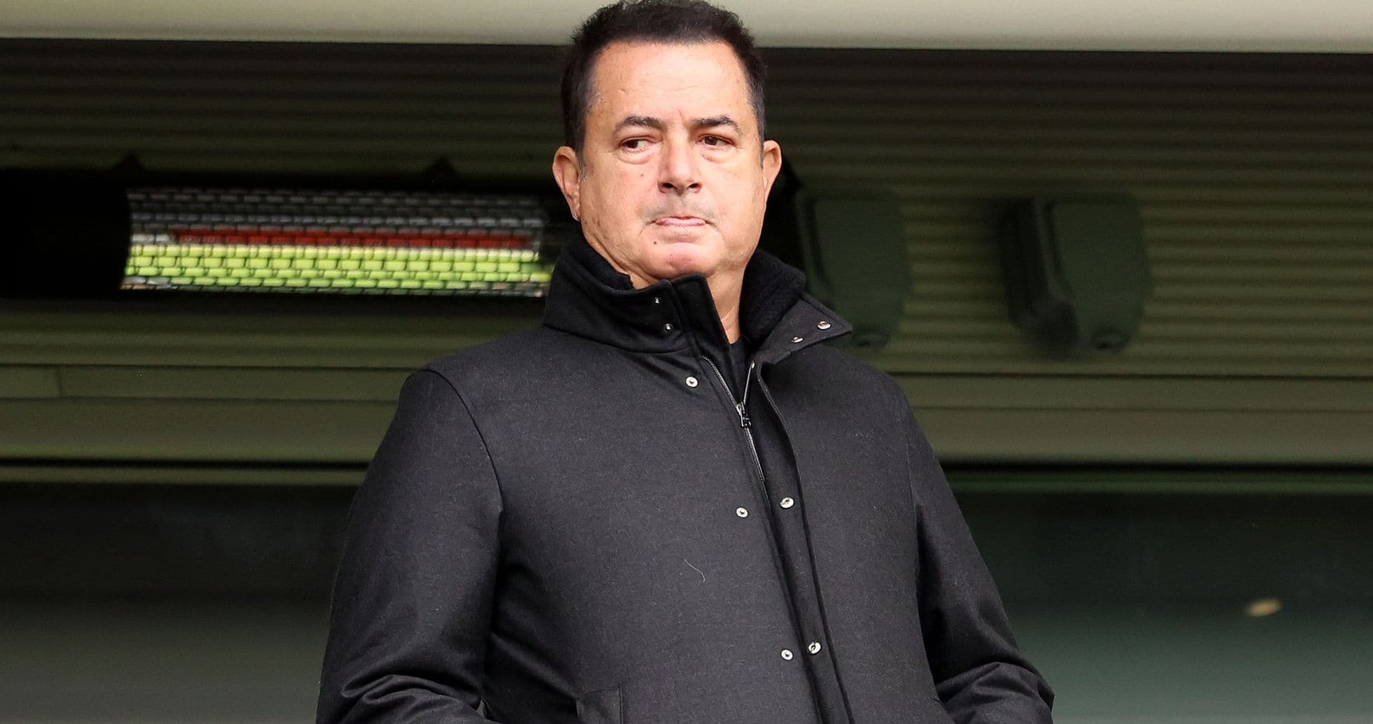 Person in black coat at sporting venue