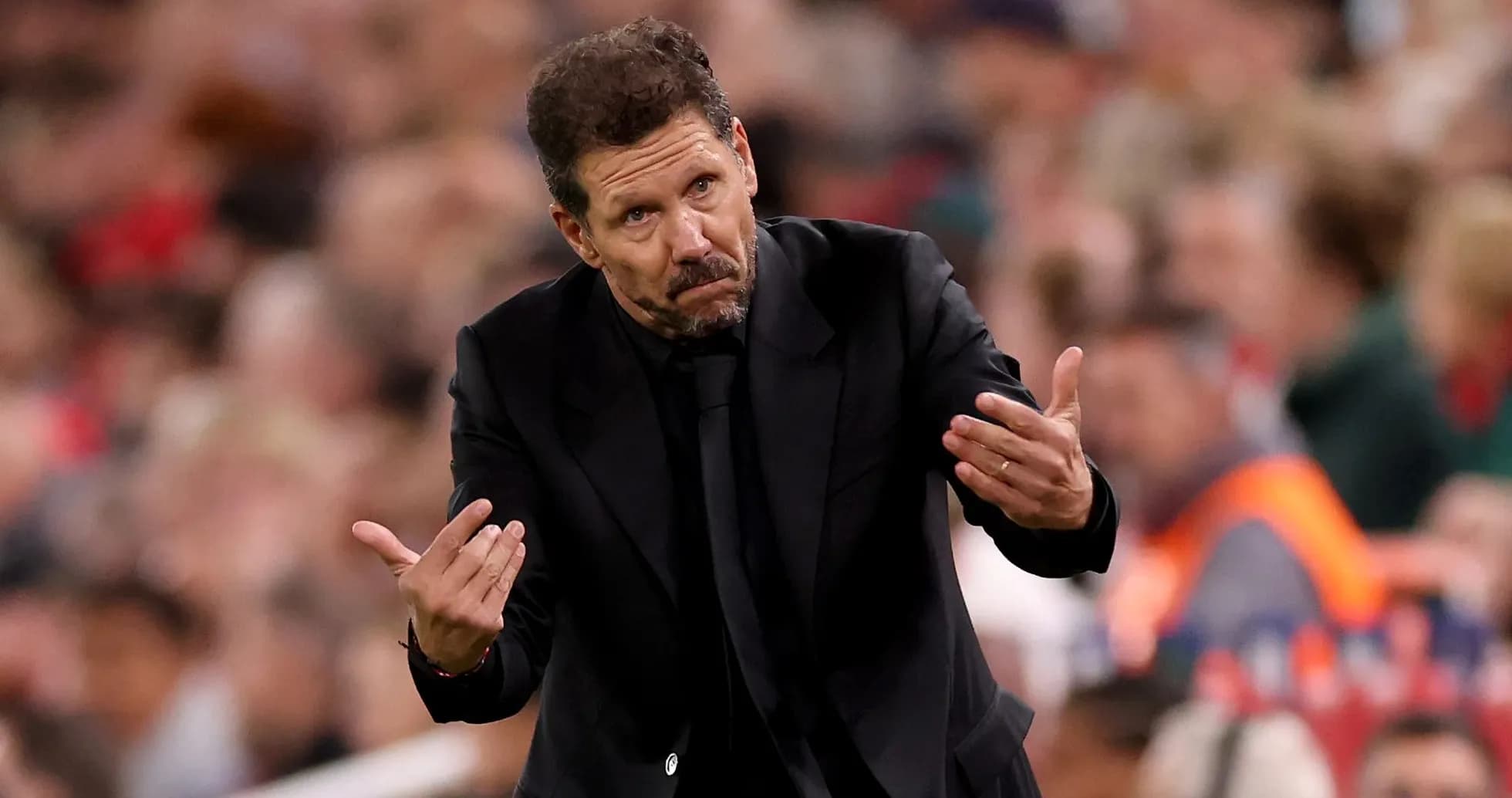 Manager gesturing during a match on the sidelines