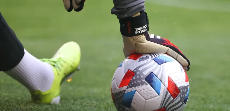 Goalkeeper holding a soccer ball on the field