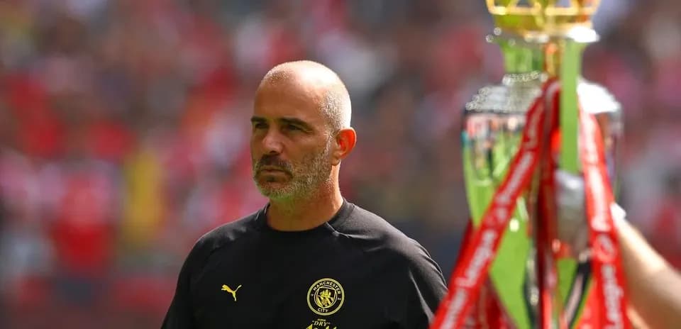 Men's football coach with trophy before match