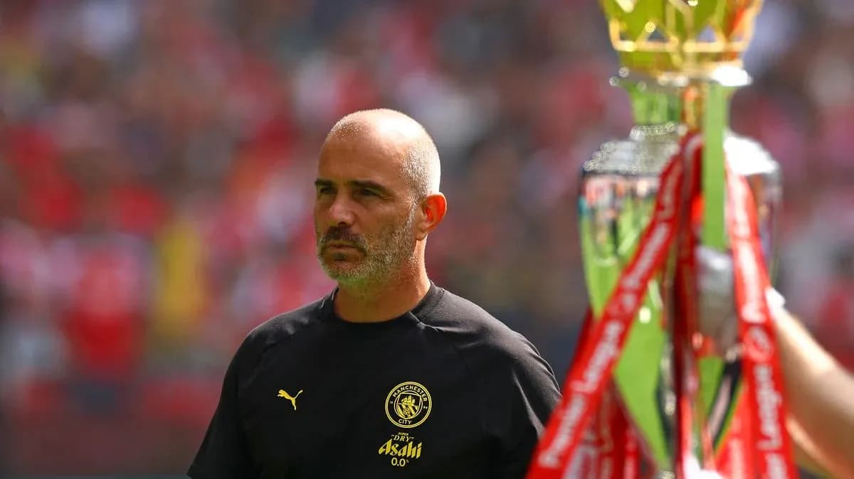 Men's football coach with trophy before match