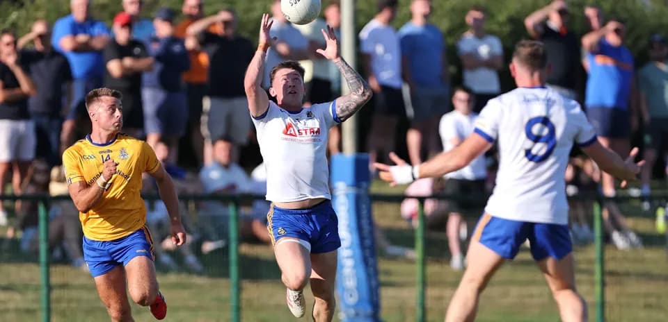 Player catching ball during Gaelic football match