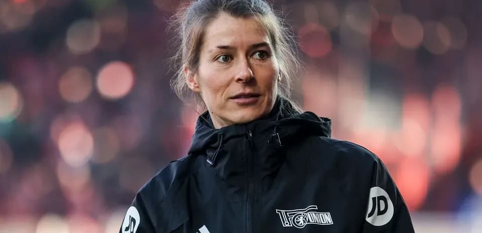 Woman in black jacket during match day preparations