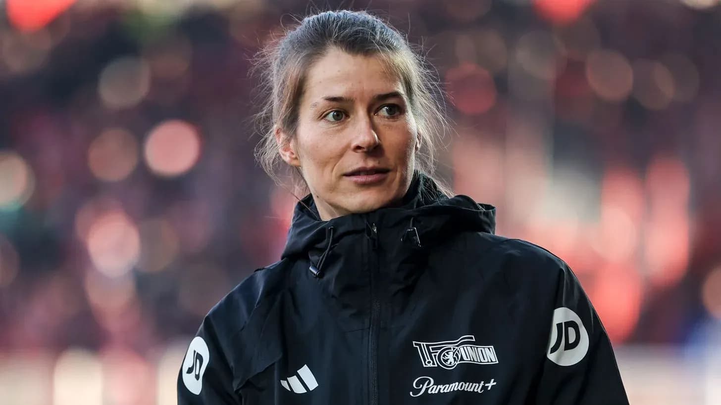 Woman in black jacket during match day preparations