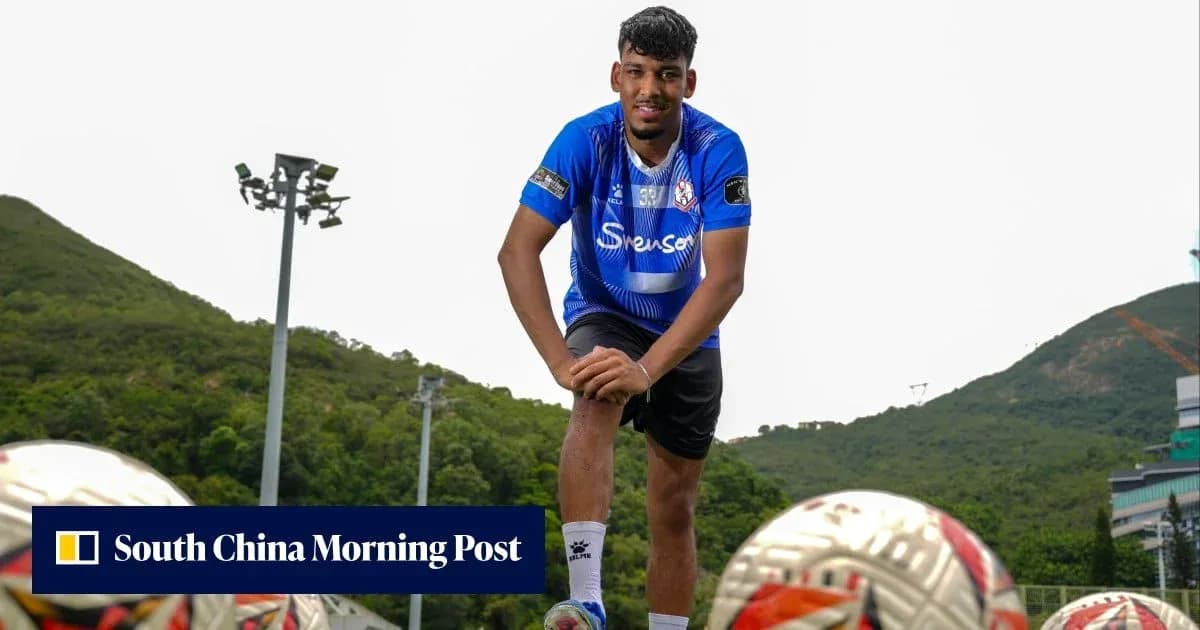 Football player posing with training balls outdoors