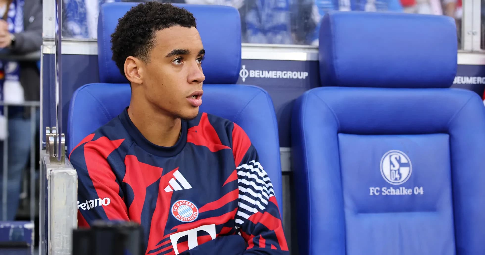 Bayern München player seated on bench during match