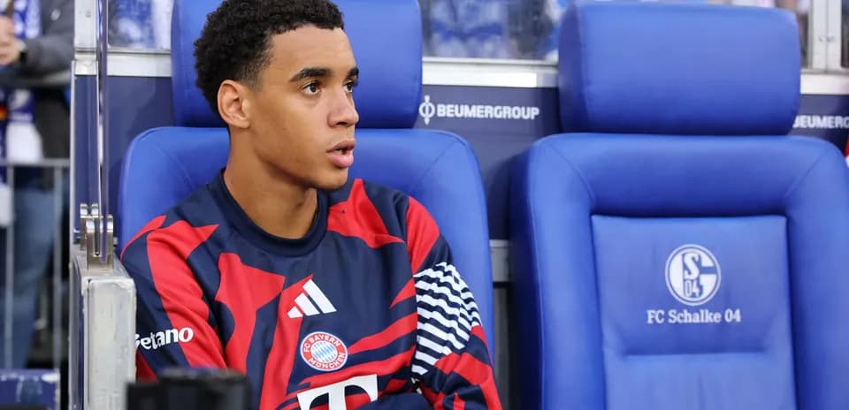 Bayern München player seated on bench during match