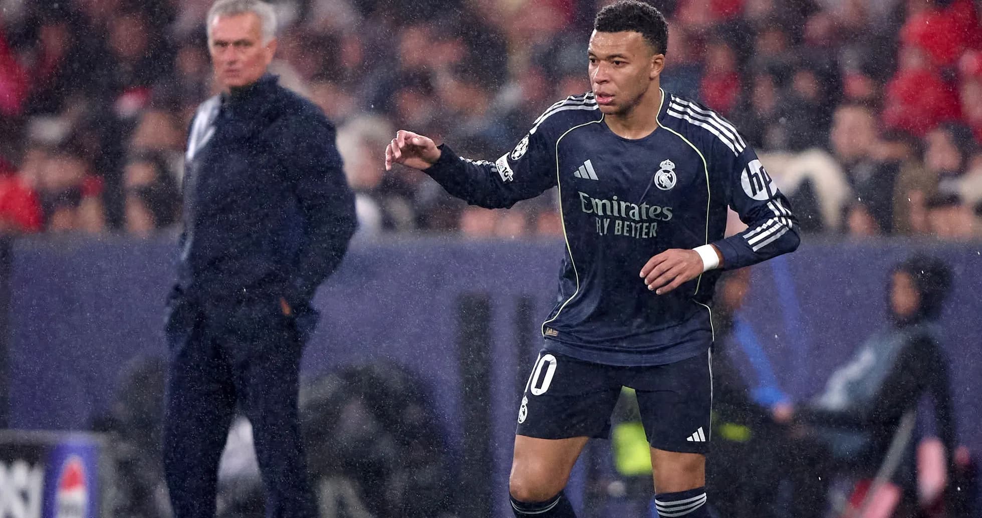 Mbappé playing for Real Madrid during rainy match