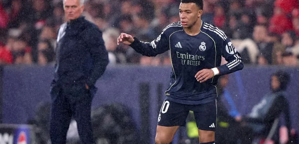 Mbappé playing for Real Madrid during rainy match
