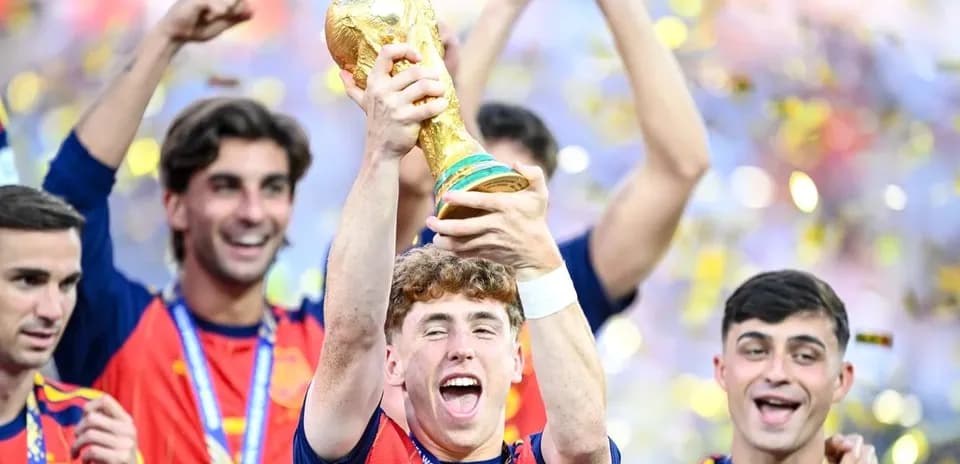 Spain players celebrating with FIFA World Cup trophy