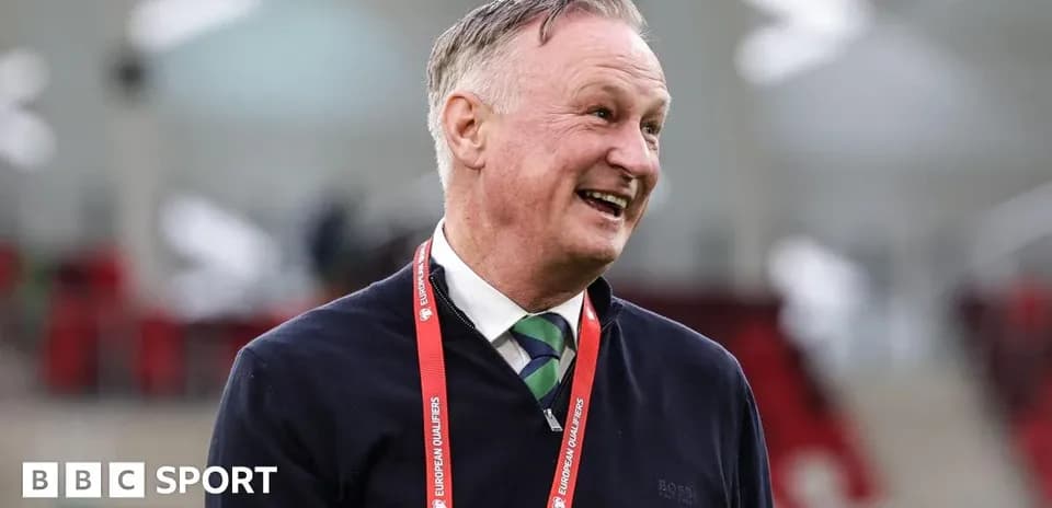 Men's football coach smiling at the stadium