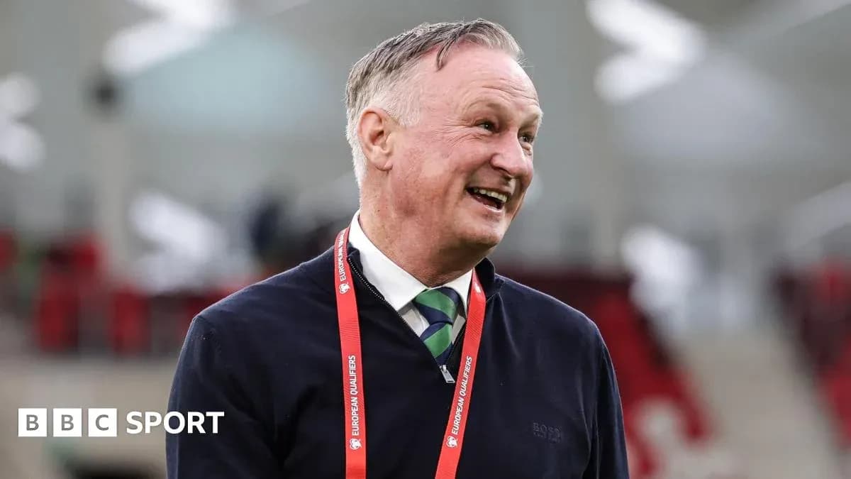 Men's football coach smiling at the stadium