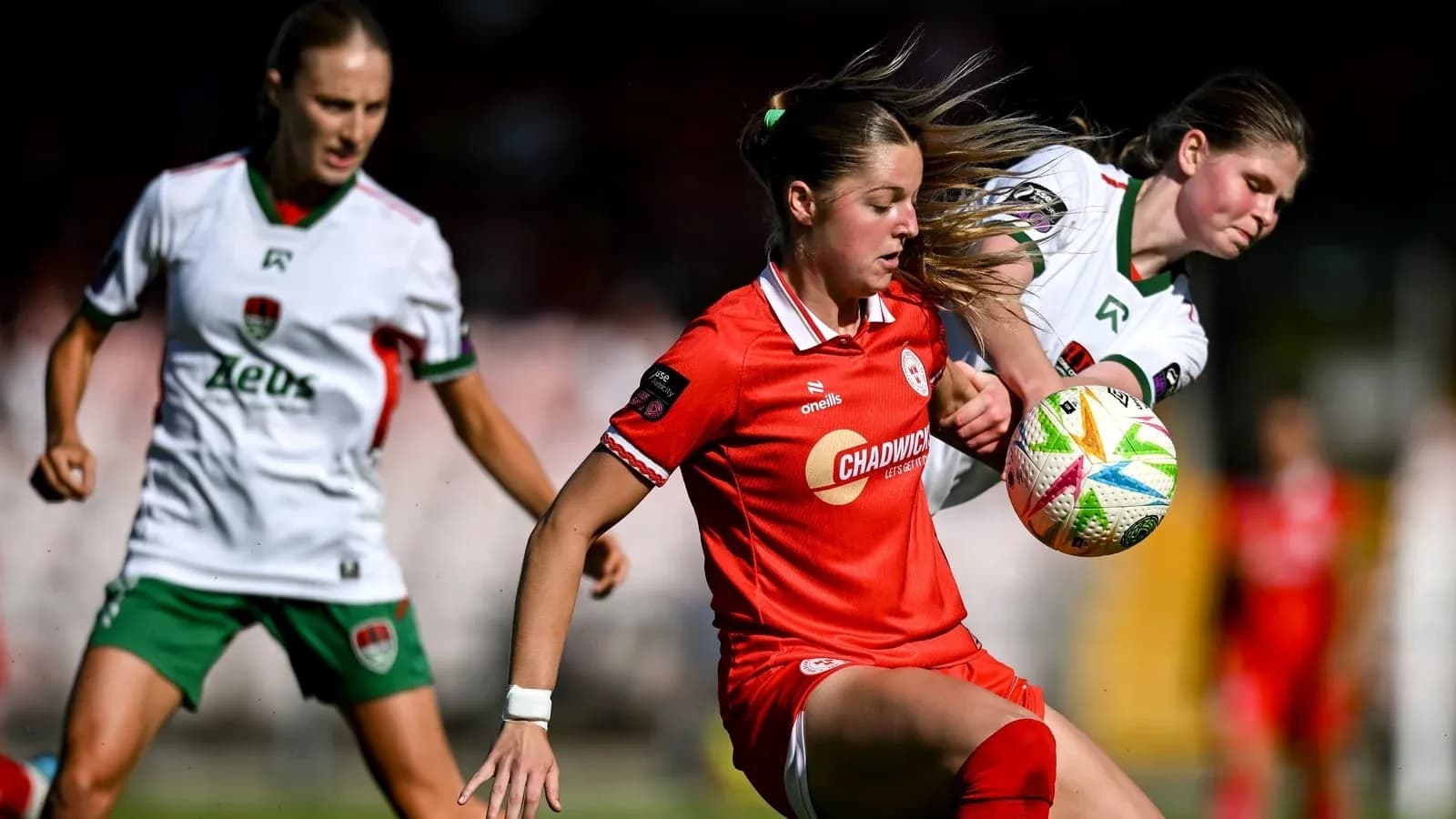 Two players contesting a soccer ball on the field