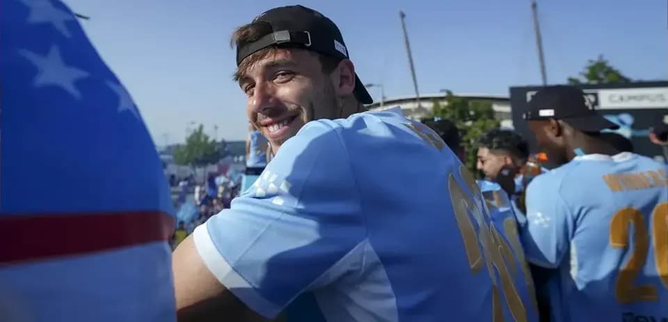 Player smiling during celebration event outdoors