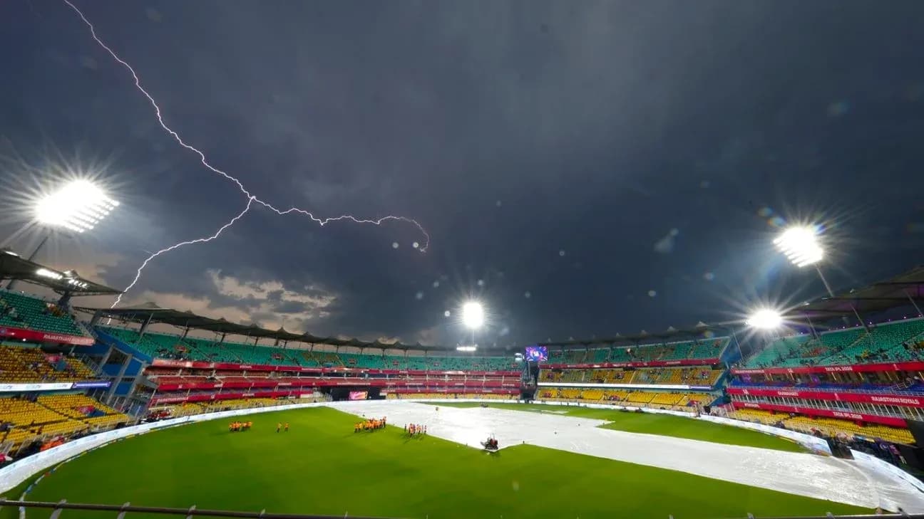 Lightning over cricket stadium with rain cover