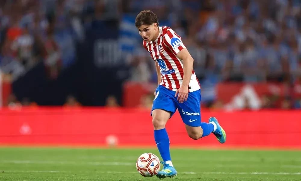 Atletico Madrid player dribbling the ball on pitch