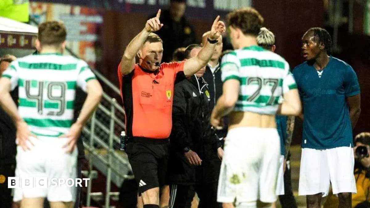 Referee signaling during match with players nearby