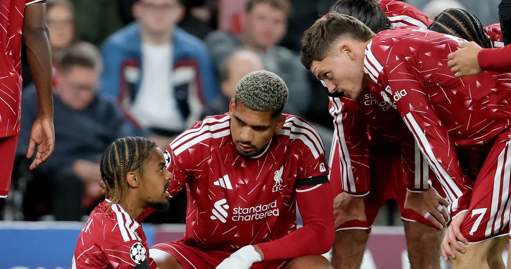 Liverpool players gathered around injured teammate