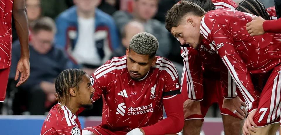 Liverpool players gathered around injured teammate