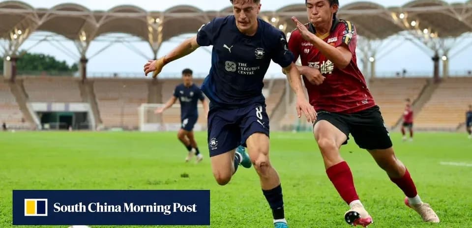 Player in blue jersey evading opponent on field